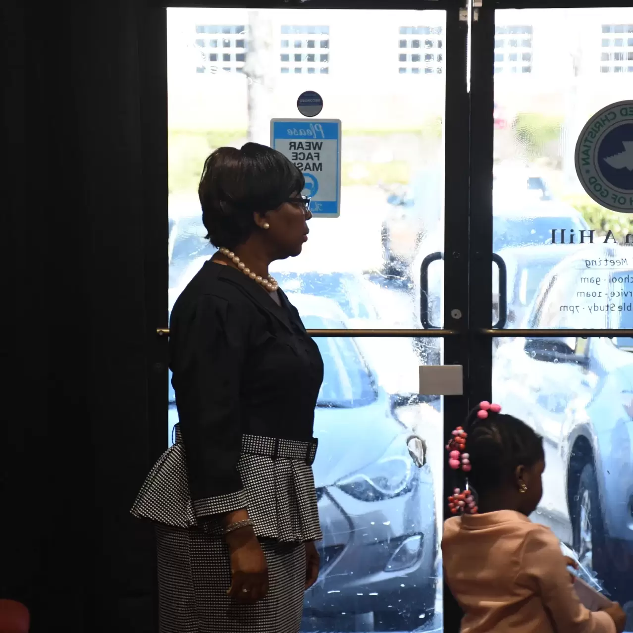 Female usher welcoming guests at RCCG City on a Hill church entrance in Lawrenceville, Georgia